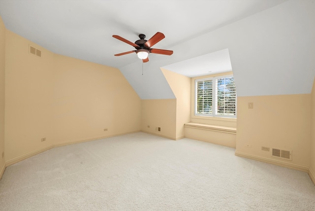 bonus room with light carpet, vaulted ceiling, and ceiling fan