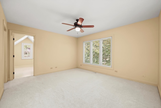 carpeted spare room featuring ceiling fan