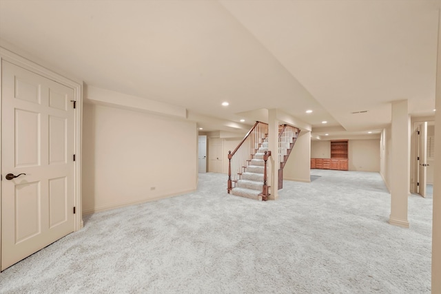 basement featuring light carpet