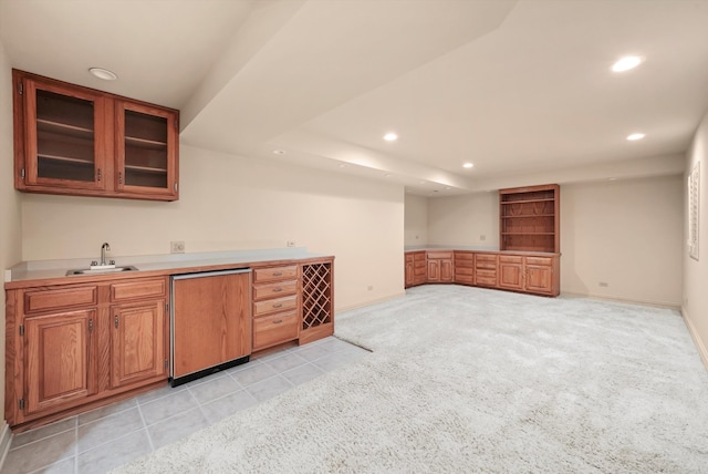 bar featuring dishwasher, sink, and light carpet