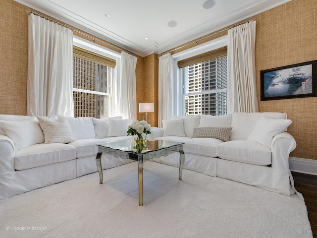 living room with hardwood / wood-style flooring and crown molding