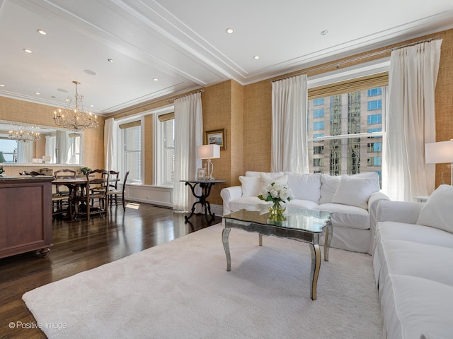 living room featuring ornamental molding, an inviting chandelier, and dark wood-type flooring