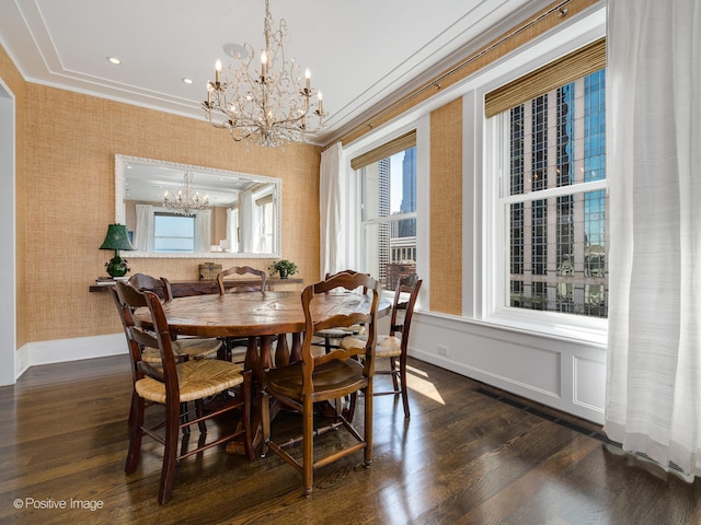 dining area with a notable chandelier, crown molding, and dark hardwood / wood-style flooring