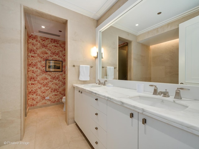 bathroom with tile patterned floors, crown molding, vanity, and toilet