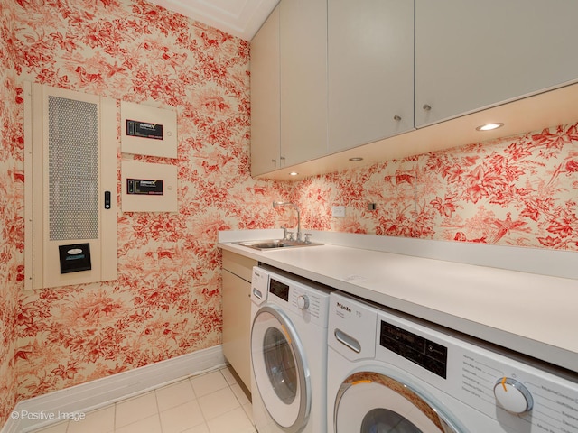 washroom featuring light tile patterned floors, cabinets, sink, and washer and dryer