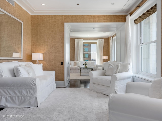 living room with ornamental molding, carpet floors, and a healthy amount of sunlight