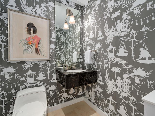 bathroom featuring ornamental molding, vanity, and toilet