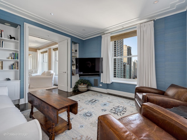 living room featuring wood-type flooring and crown molding