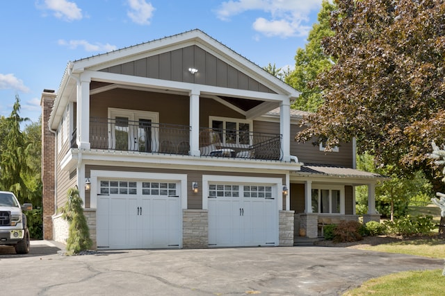 craftsman-style home featuring a balcony and a garage