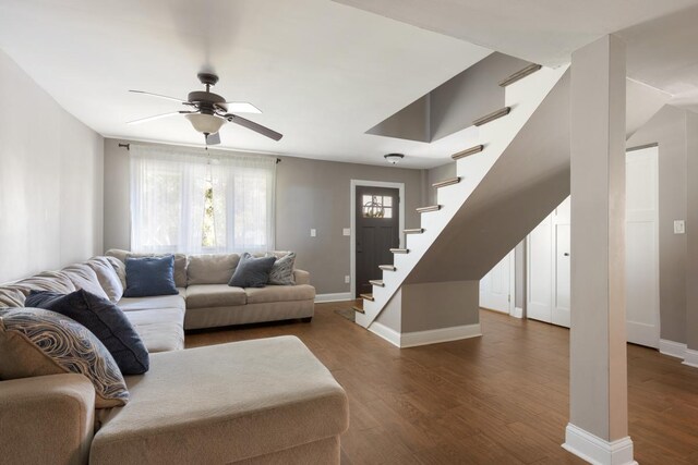 living room with ceiling fan and dark hardwood / wood-style floors