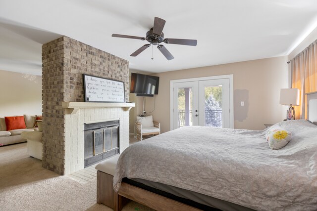 carpeted bedroom featuring french doors, ceiling fan, access to exterior, and a fireplace