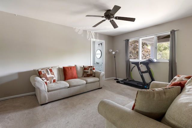 carpeted living room with ceiling fan