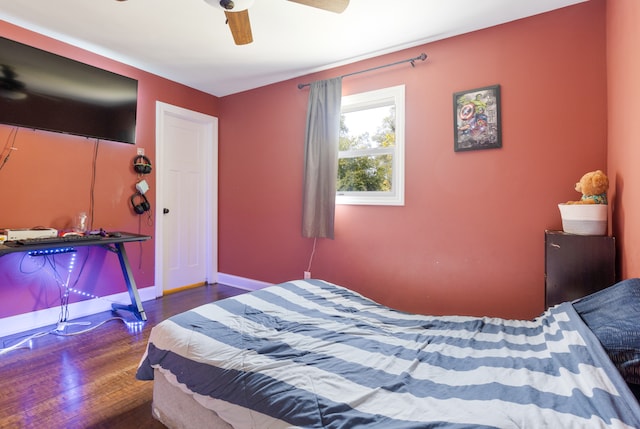 bedroom with ceiling fan and dark wood-type flooring