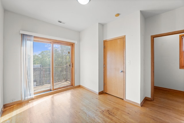 unfurnished bedroom featuring light wood-type flooring and access to exterior