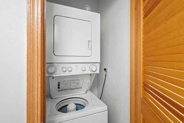 washroom featuring stacked washing maching and dryer