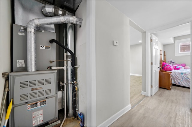 utility room featuring heating unit