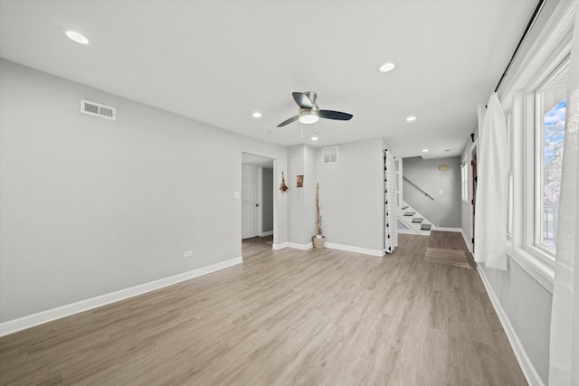 spare room with light wood-type flooring and ceiling fan