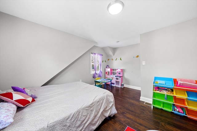 bedroom with dark hardwood / wood-style floors