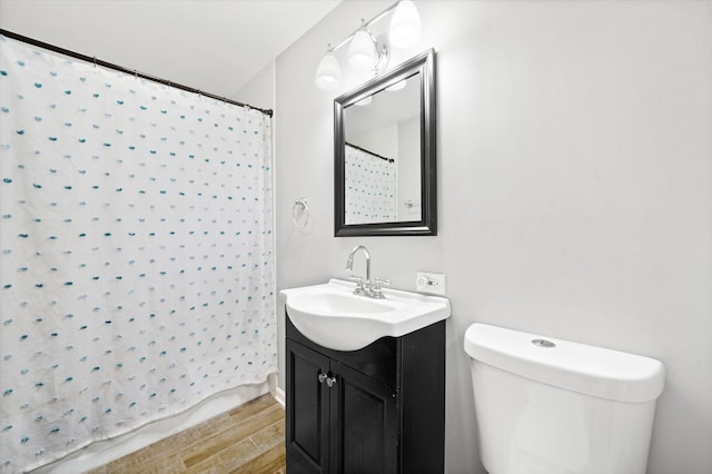 bathroom featuring vanity, toilet, a shower with curtain, and hardwood / wood-style floors