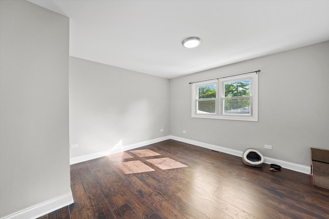 spare room featuring dark hardwood / wood-style floors