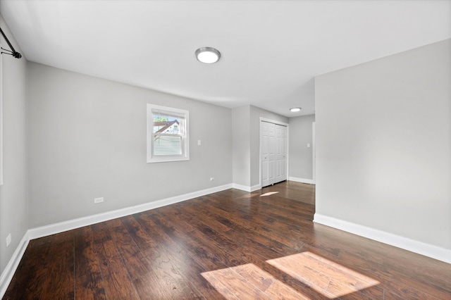 spare room with dark hardwood / wood-style floors