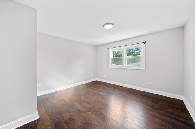 empty room with dark hardwood / wood-style floors