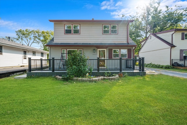 exterior space with a deck and a lawn