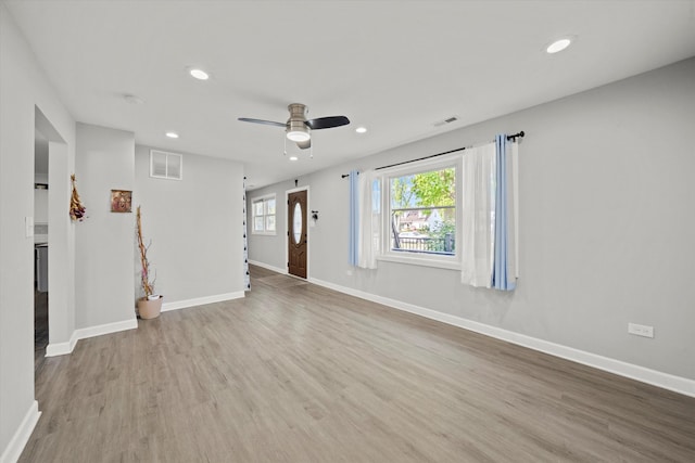 unfurnished room with ceiling fan and light wood-type flooring