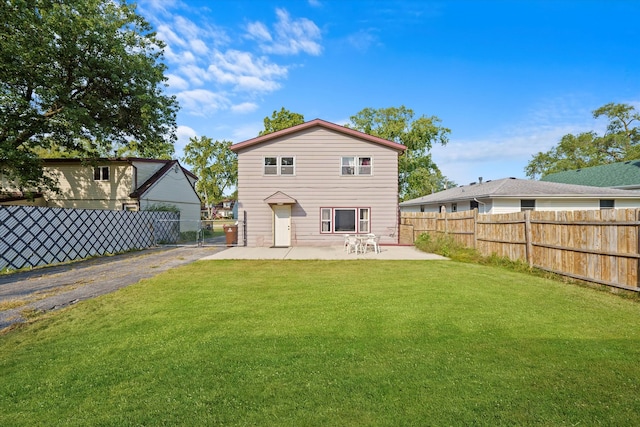 back of property with a yard and a patio area