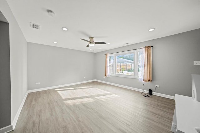 empty room with light hardwood / wood-style flooring and ceiling fan