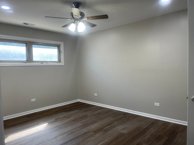 empty room with ceiling fan and dark hardwood / wood-style floors