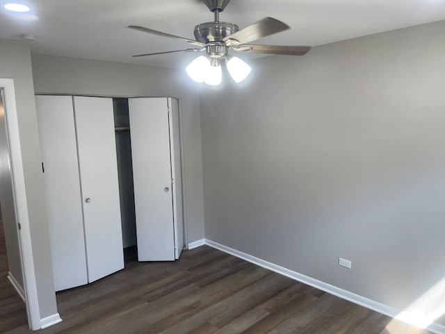 unfurnished bedroom with a closet, ceiling fan, and dark hardwood / wood-style floors