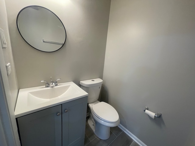 bathroom featuring vanity, toilet, and tile patterned floors