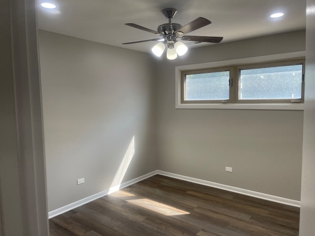 empty room featuring ceiling fan and dark hardwood / wood-style flooring