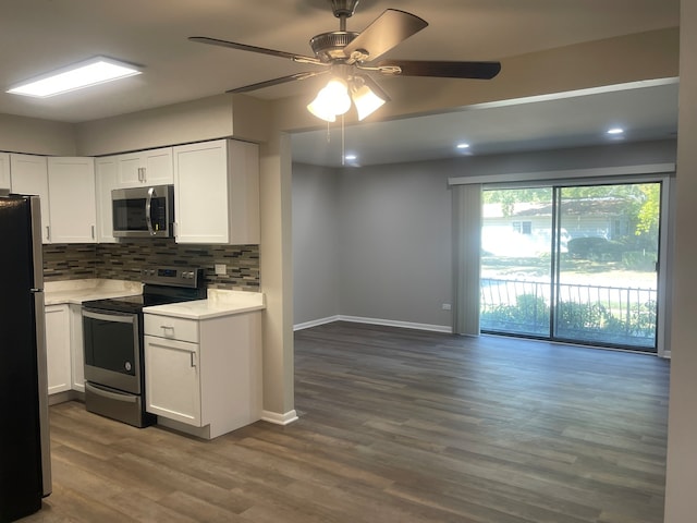 kitchen featuring white cabinetry, backsplash, stainless steel appliances, wood-type flooring, and ceiling fan