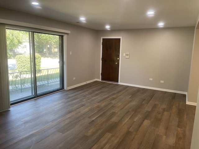 unfurnished room with dark wood-type flooring