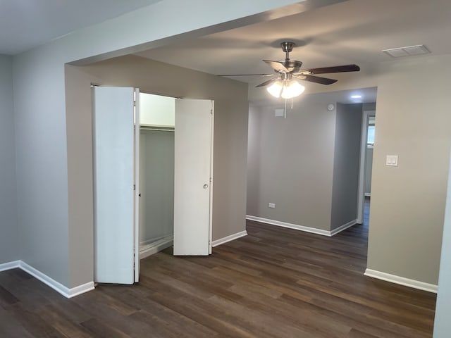 spare room featuring ceiling fan and dark hardwood / wood-style flooring