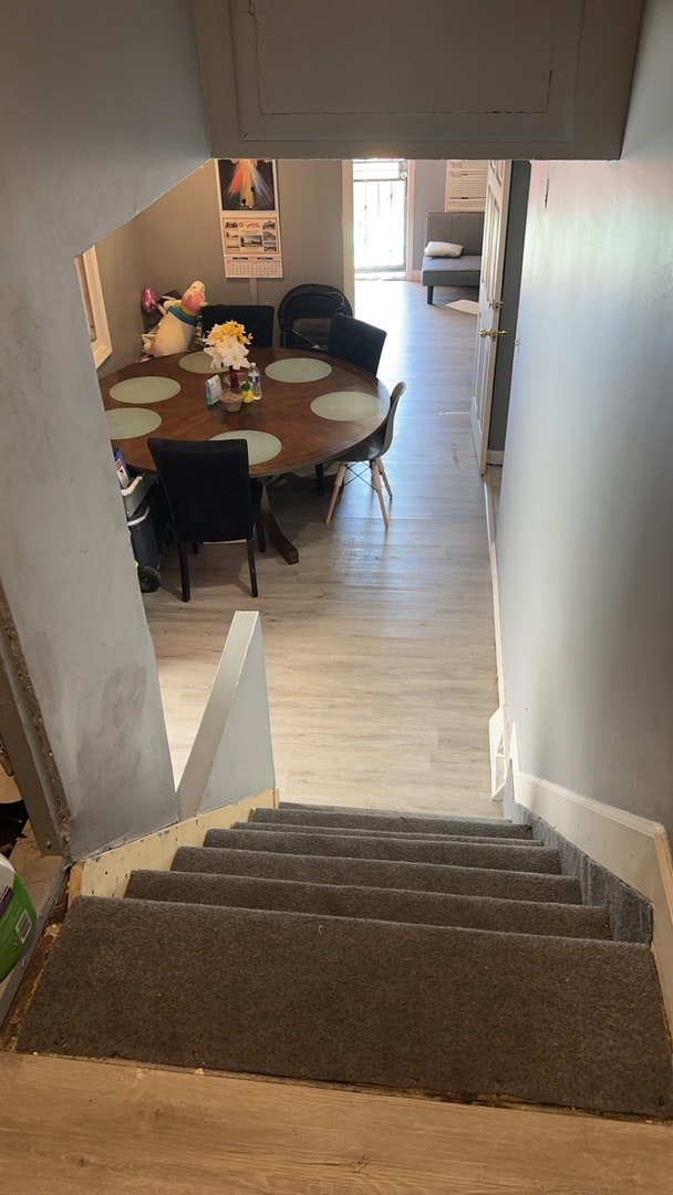 stairs featuring hardwood / wood-style floors