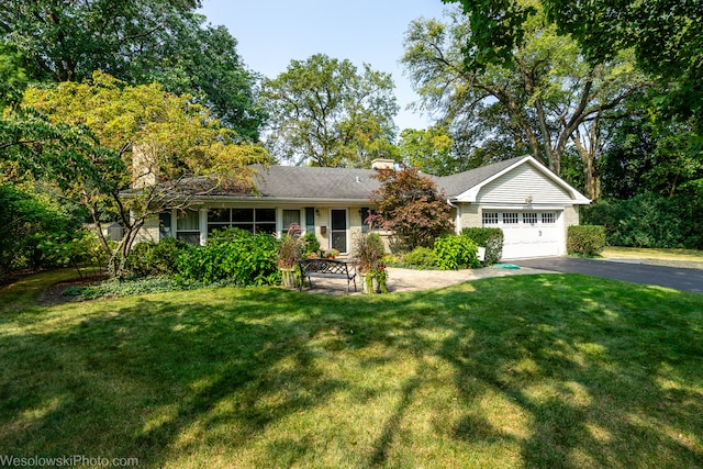 ranch-style house featuring a garage and a front yard