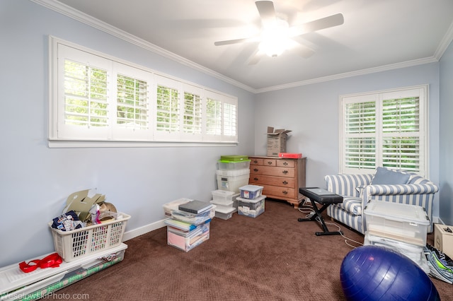 rec room featuring ceiling fan, crown molding, and dark colored carpet