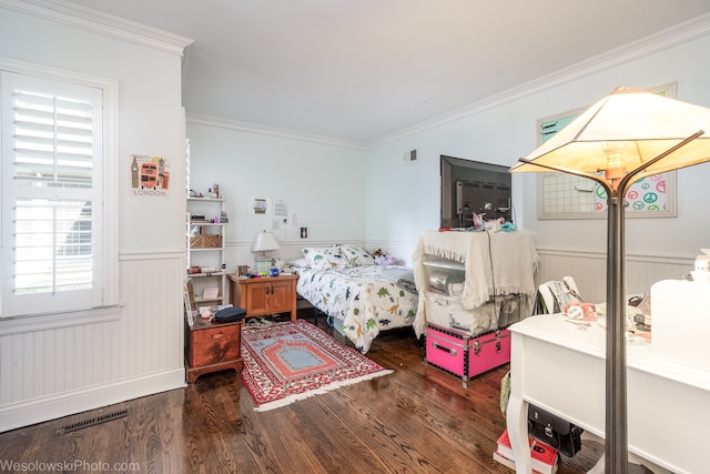 bedroom with dark hardwood / wood-style flooring and crown molding