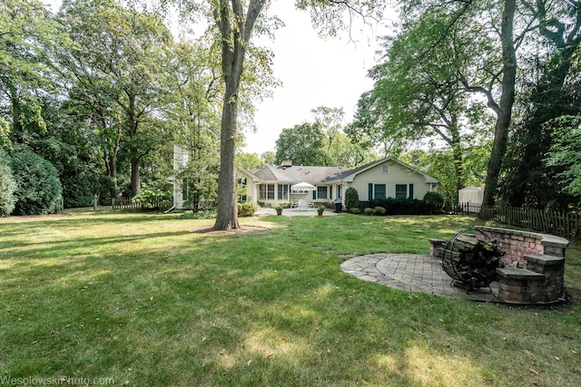 view of yard with a patio area and an outdoor fire pit