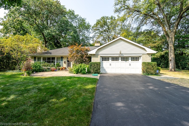 ranch-style house with a garage and a front yard