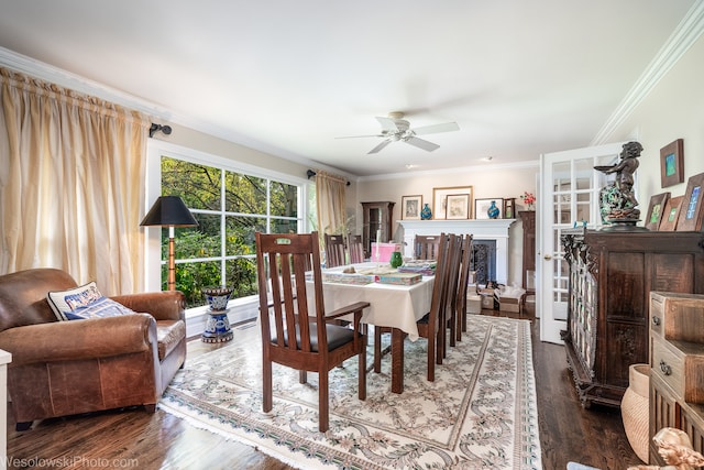 dining room with ornamental molding, wood-type flooring, and ceiling fan