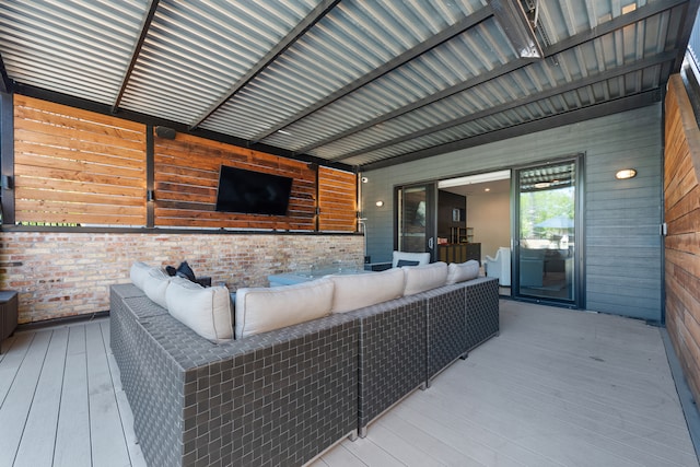 wooden terrace with an outdoor living space