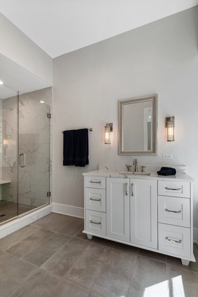 bathroom featuring tile patterned flooring, vanity, and a shower with shower door