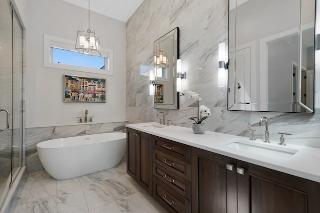 bathroom featuring plus walk in shower, tile walls, a notable chandelier, and vanity