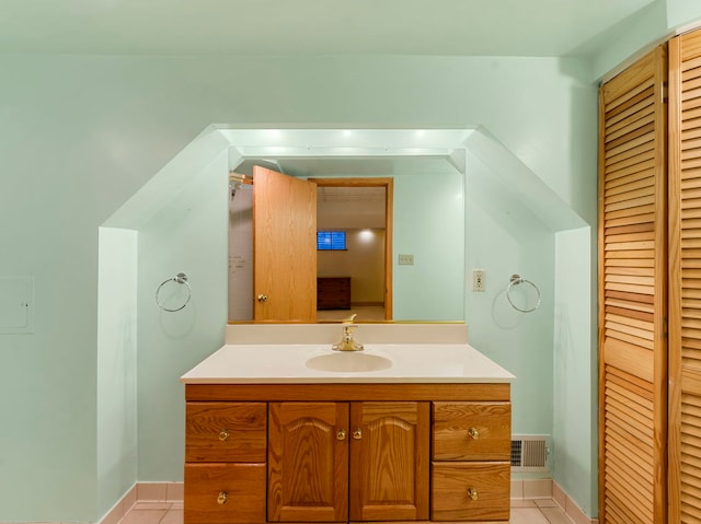 bathroom featuring tile patterned flooring and vanity