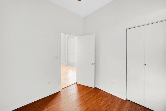 unfurnished bedroom featuring hardwood / wood-style floors and a closet