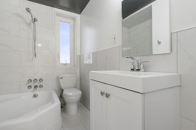 full bathroom featuring tile walls, tiled shower / bath combo, vanity, and toilet